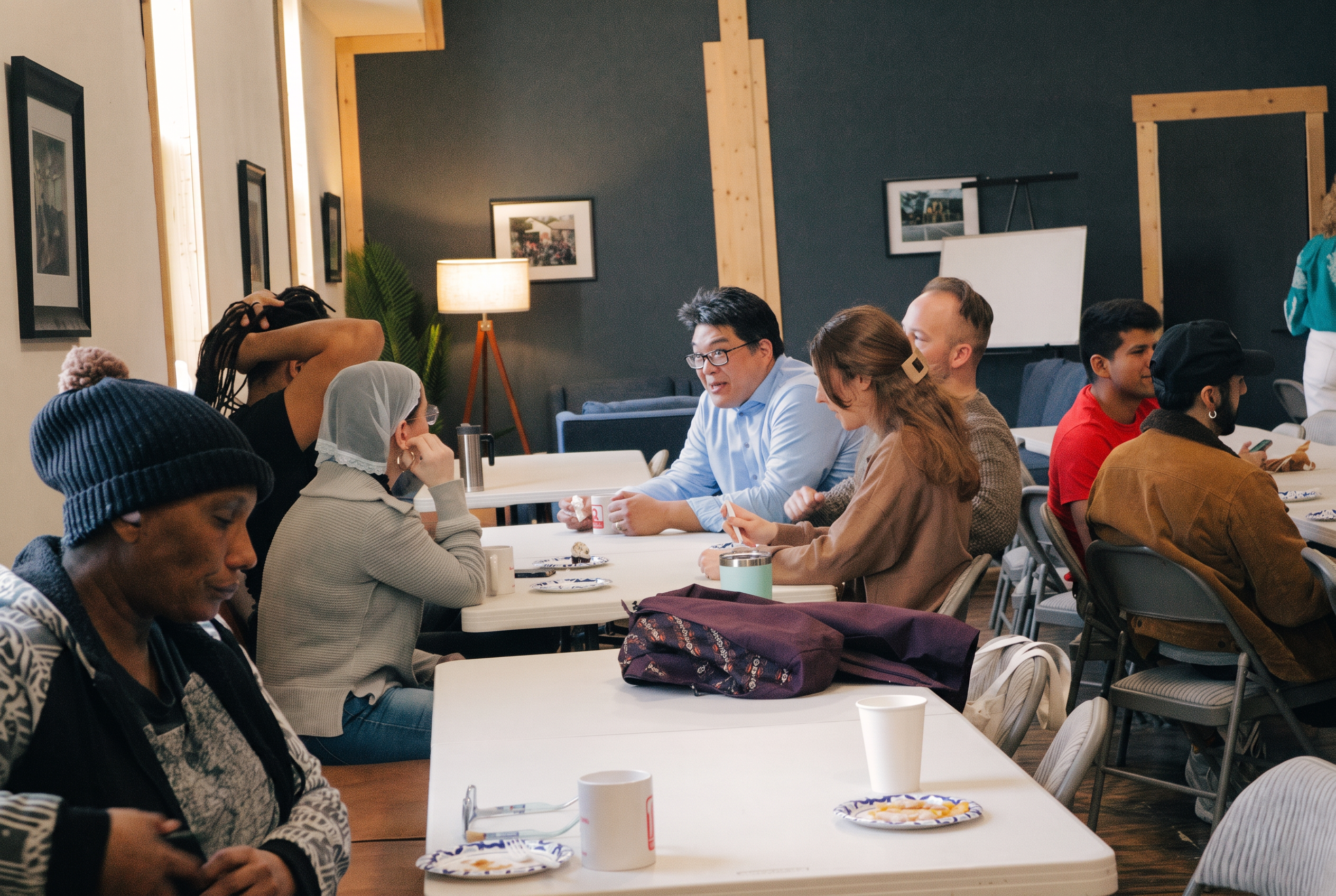 Community gathered around tables in conversation